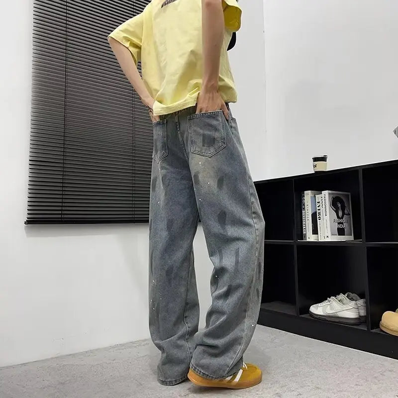 Washed and distressed splashed ink denim jeans for men Markonline